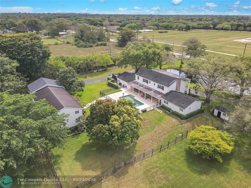 8585 Ranch Road Parkland, FL 33067 - Photo 47 of 69 an aerial view of residential houses with outdoor space and river