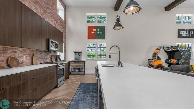 8585 Ranch Road Parkland, FL 33067 - Photo 53 of 69 a kitchen with sink a stove and cabinets