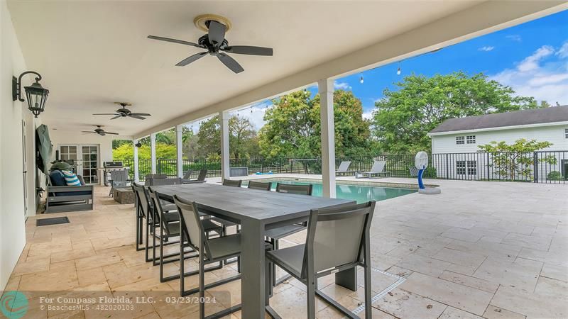 8585 Ranch Road Parkland, FL 33067 - Photo 60 of 69 a view of a patio with a table chairs and a backyard