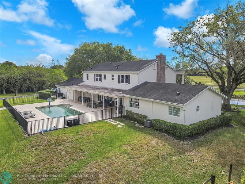 8585 Ranch Road Parkland, FL 33067 - Photo 66 of 69 a aerial view of a house with a big yard and large trees