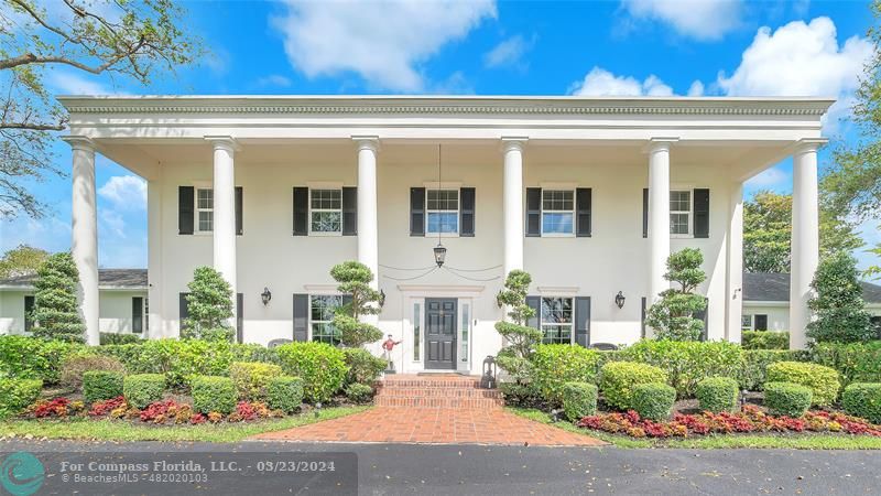 8585 Ranch Road Parkland, FL 33067 - Photo 67 of 69 a front view of a house with lots of flowers