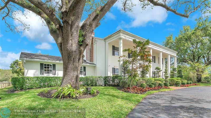 8585 Ranch Road Parkland, FL 33067 - Photo 7 of 69 a front view of a house with a yard