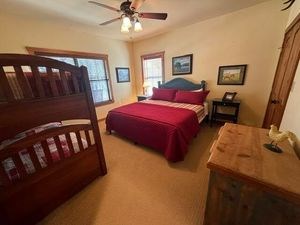 215 70l Rd Junction Junction, TX 76849 - Photo 15 of 43 a bedroom with two beds and a baby crib