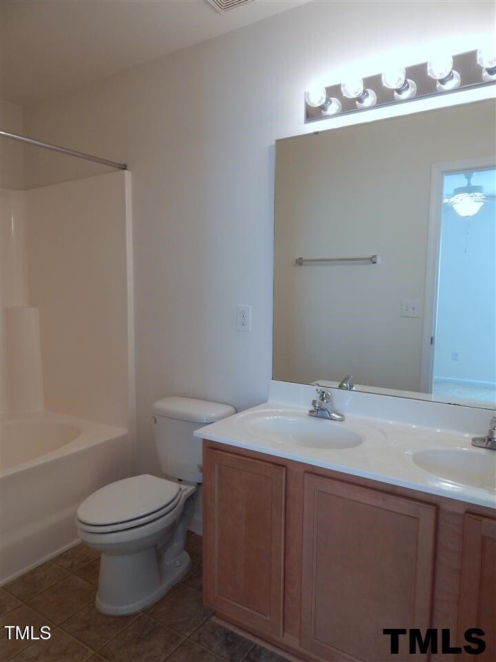 2403 Savior Street Raleigh, NC 27610 - Photo 14 of 21 a bathroom with a sink a toilet and mirror