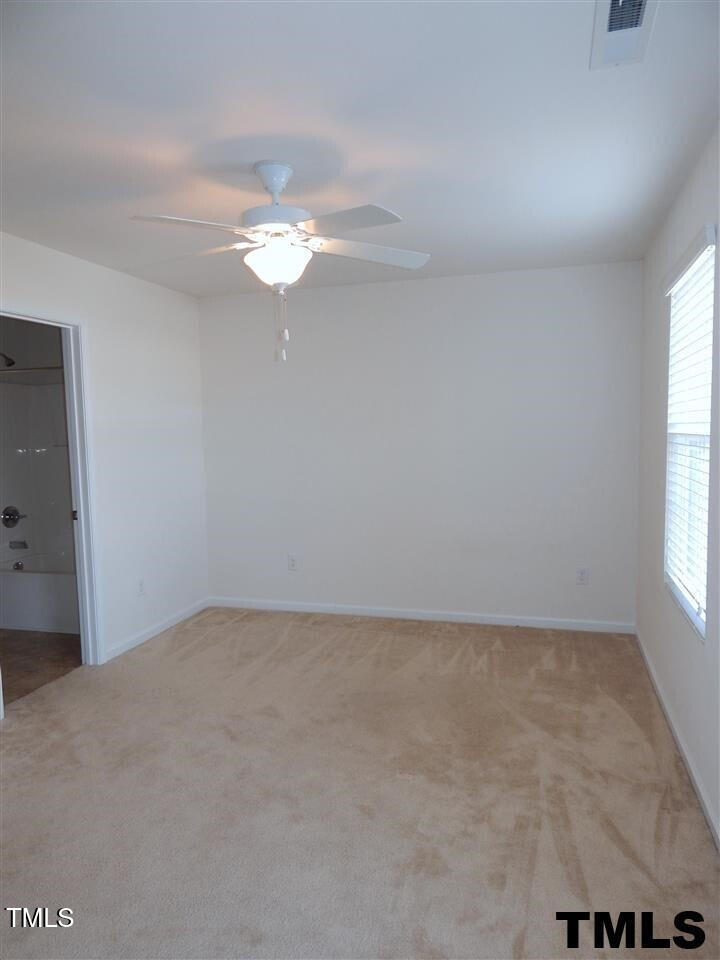2403 Savior Street Raleigh, NC 27610 - Photo 17 of 21 an empty room with a window and a ceiling fan