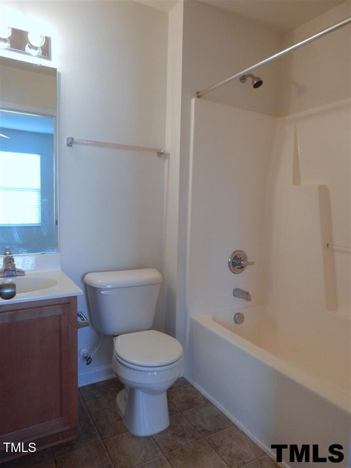 2403 Savior Street Raleigh, NC 27610 - Photo 18 of 21 a white toilet sitting next to a bath tub