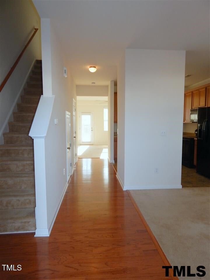 2403 Savior Street Raleigh, NC 27610 - Photo 3 of 21 a view of a hallway with wooden floor
