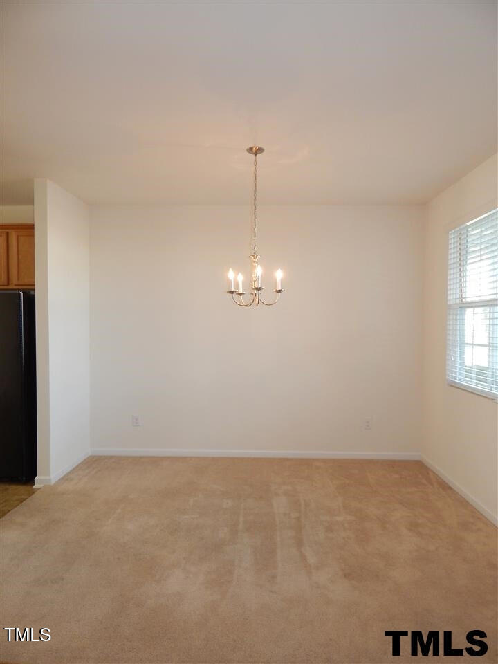 2403 Savior Street Raleigh, NC 27610 - Photo 4 of 21 an empty room with chandelier fan