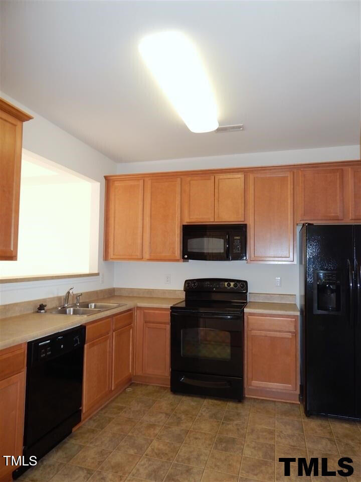 2403 Savior Street Raleigh, NC 27610 - Photo 6 of 21 a kitchen with a sink stove and microwave