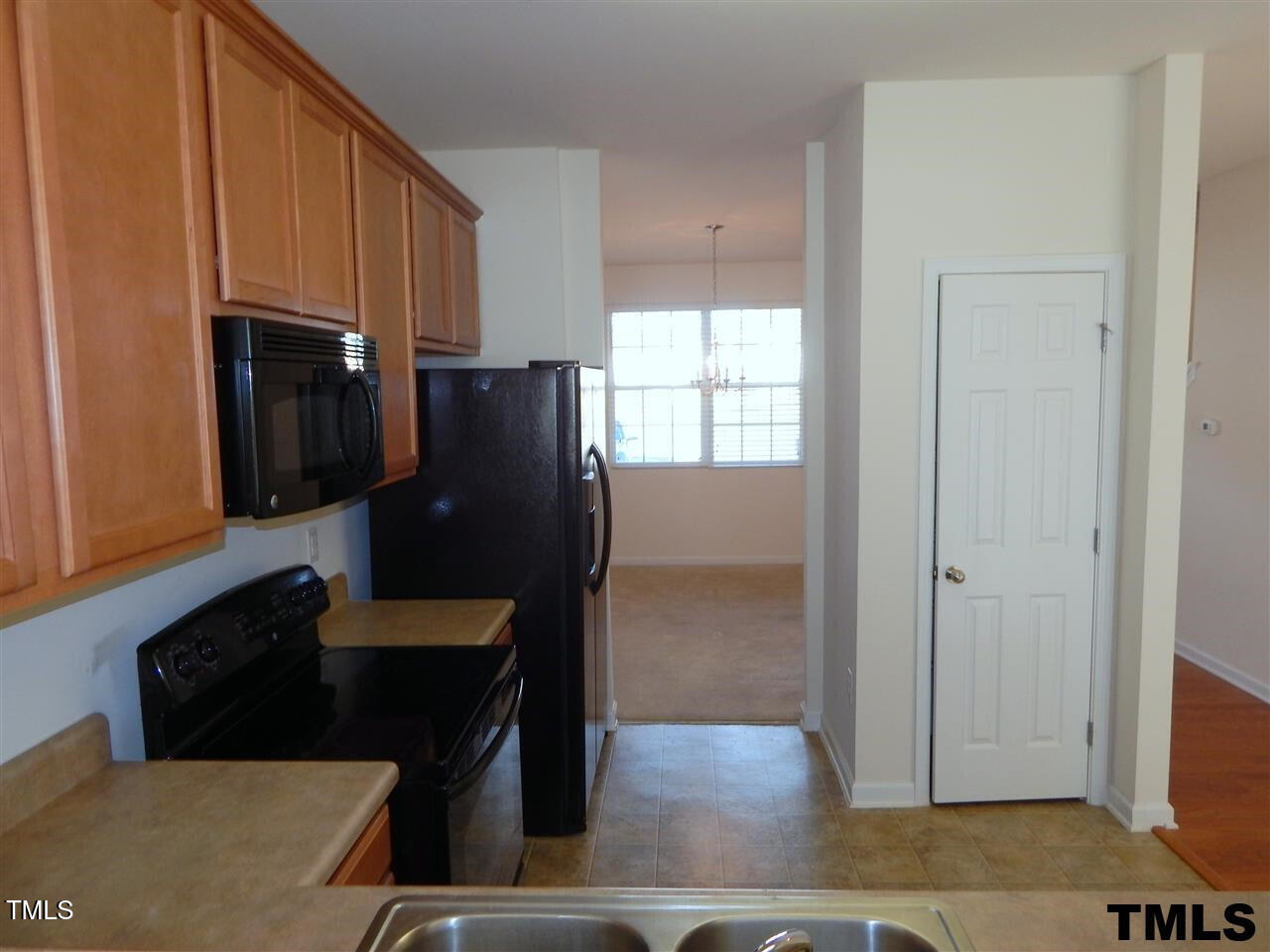 2403 Savior Street Raleigh, NC 27610 - Photo 7 of 21 a kitchen with stainless steel appliances granite countertop a refrigerator a stove and a sink with wooden cabinets