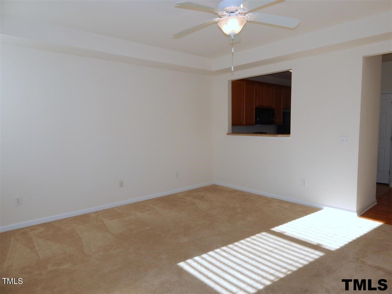 2403 Savior Street Raleigh, NC 27610 - Photo 10 of 21 a view of an empty room with a window and a kitchen