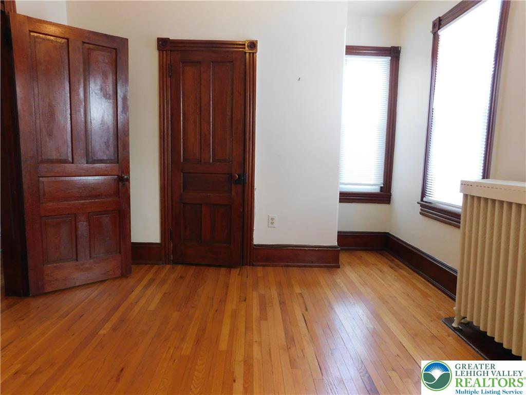 300 South 9th Street, Unit 2/UPSTAIRS Lehighton, PA 18235 - Photo 17 of 19 an empty room with wooden floor closet and windows