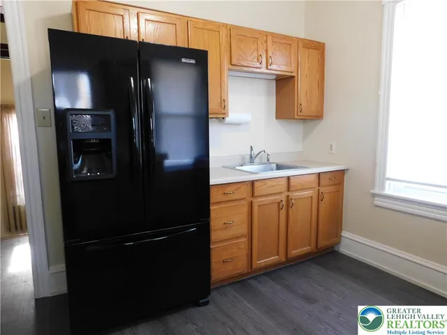 a kitchen with a refrigerator and cabinets