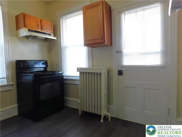 a kitchen with a refrigerator and a stove