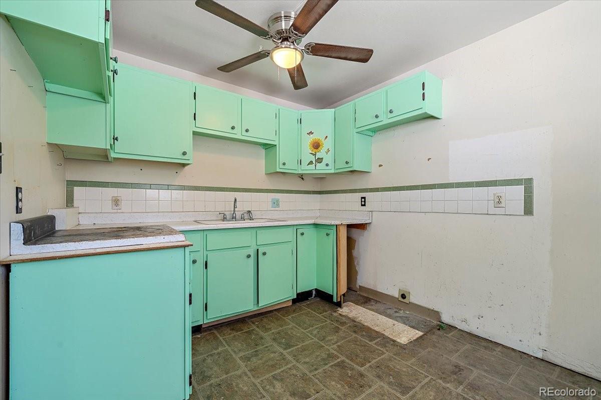 4551 Hilltop Road Evergreen, CO 80439 - Photo 13 of 30 a kitchen with a sink cabinets and a window