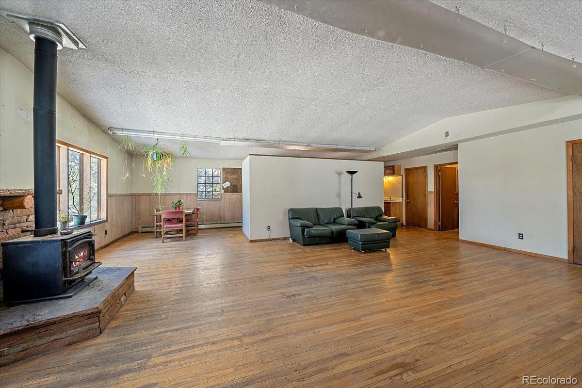 4551 Hilltop Road Evergreen, CO 80439 - Photo 2 of 30 a view of a livingroom with furniture and a flat screen tv