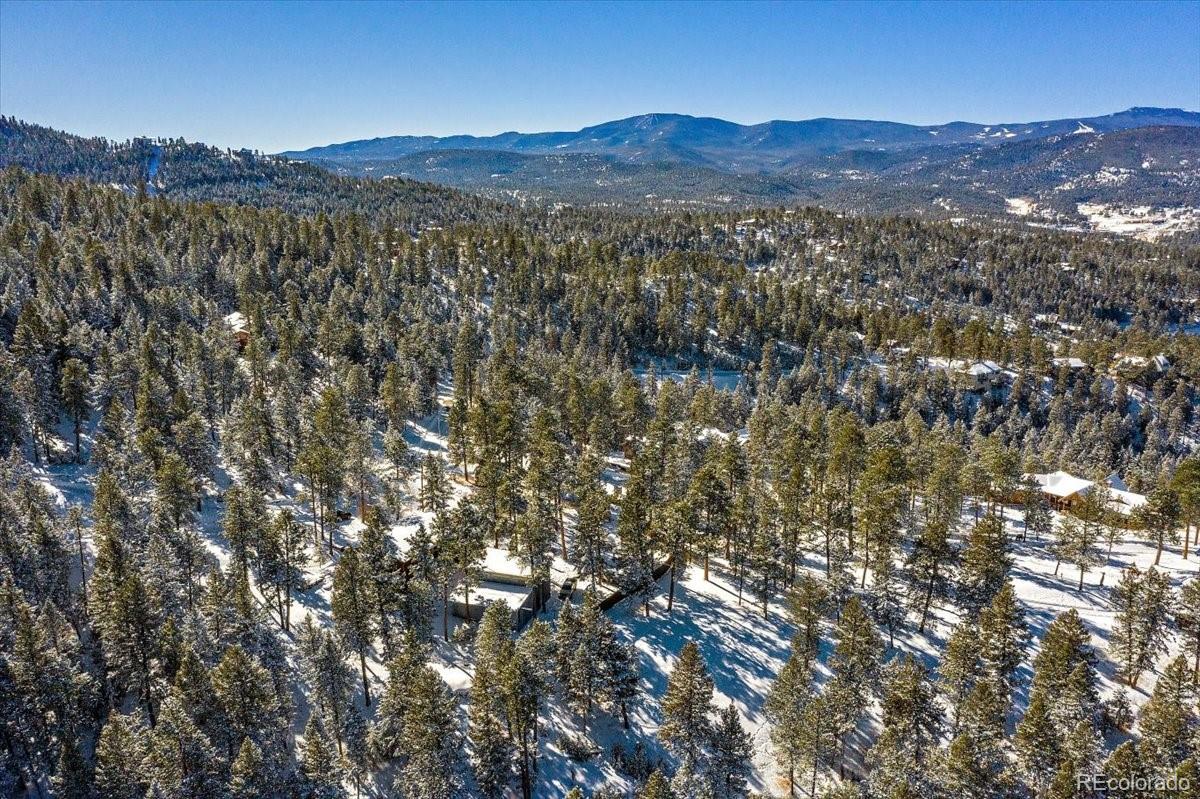 4551 Hilltop Road Evergreen, CO 80439 - Photo 25 of 30 a view of a mountain in the distance in a field