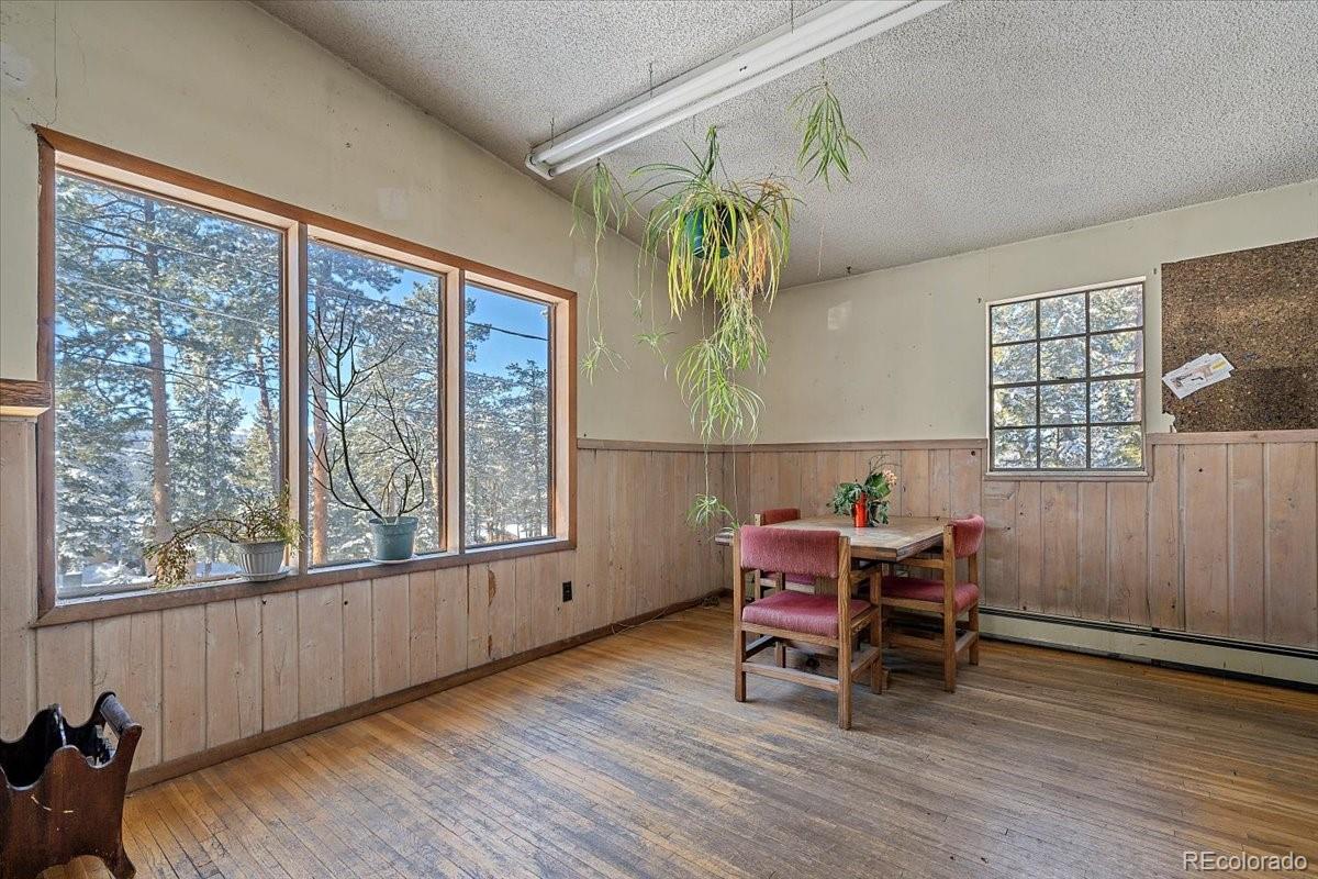 4551 Hilltop Road Evergreen, CO 80439 - Photo 6 of 30 a living room with furniture and a wooden floor