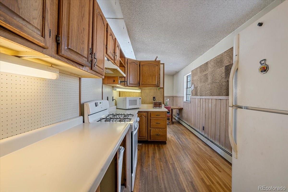 4551 Hilltop Road Evergreen, CO 80439 - Photo 8 of 30 a kitchen with a sink appliances and cabinets
