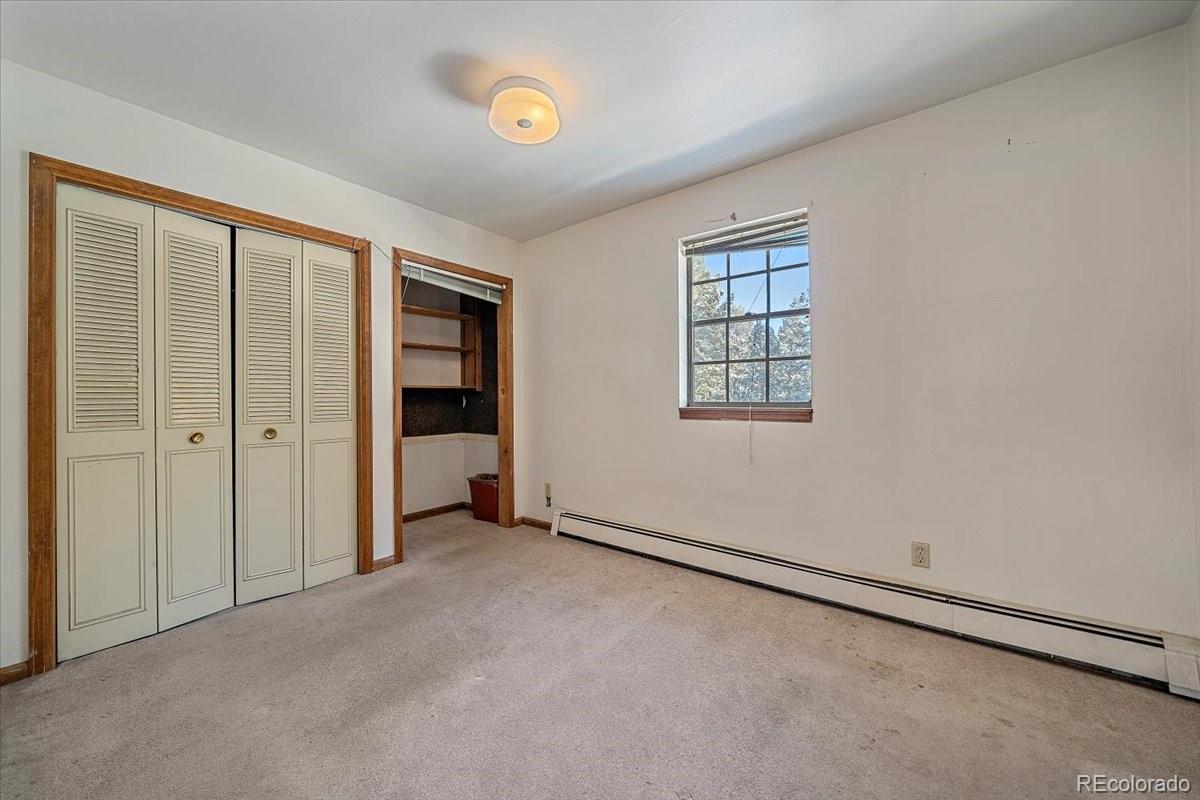 4551 Hilltop Road Evergreen, CO 80439 - Photo 10 of 30 an empty room with windows