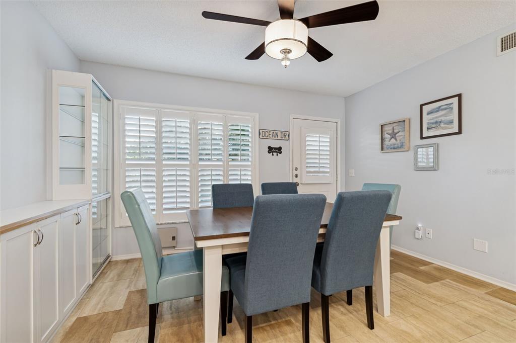 2291 Americus Boulevard West, Unit 3 Clearwater, FL 33763 - Photo 18 of 88 a view of a dining room with furniture window and wooden floor