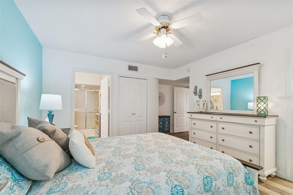 2291 Americus Boulevard West, Unit 3 Clearwater, FL 33763 - Photo 26 of 88 a bedroom with a bed and a chandelier