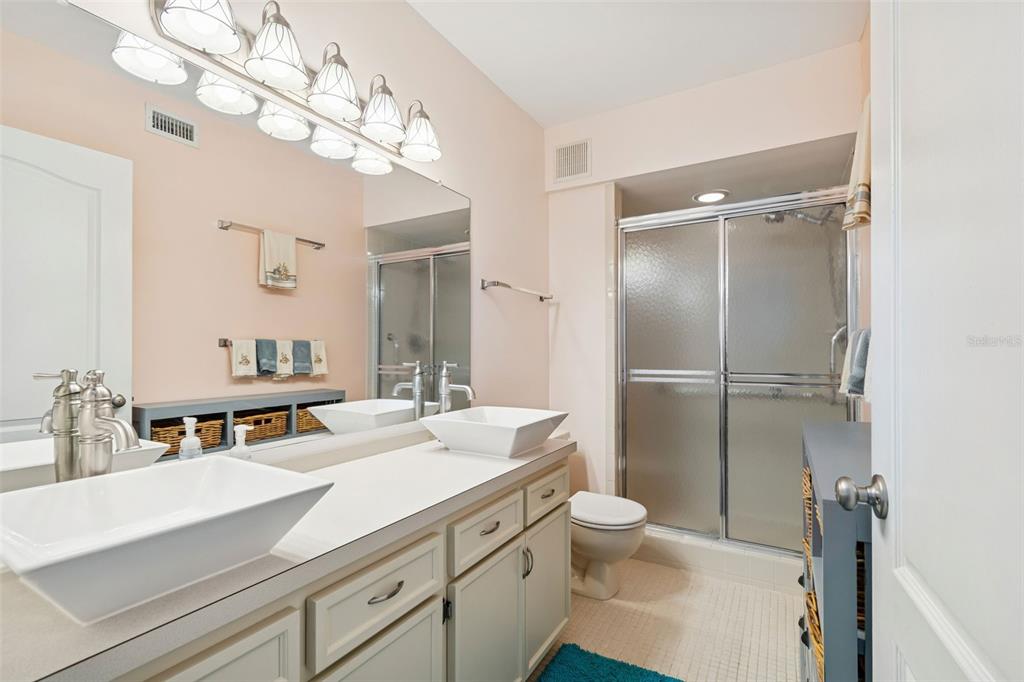 2291 Americus Boulevard West, Unit 3 Clearwater, FL 33763 - Photo 28 of 88 a bathroom with a sink a toilet and a mirror