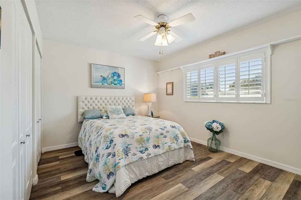 2291 Americus Boulevard West, Unit 3 Clearwater, FL 33763 - Photo 31 of 88 a bedroom with a bed and painting on the wall