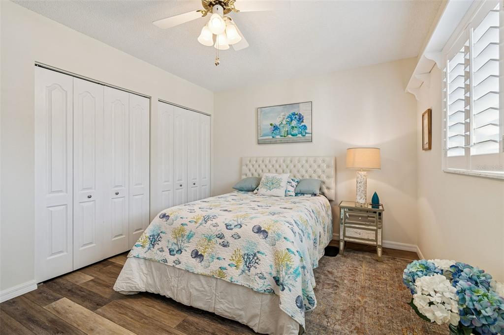 2291 Americus Boulevard West, Unit 3 Clearwater, FL 33763 - Photo 33 of 88 a bedroom with a bed and a chandelier