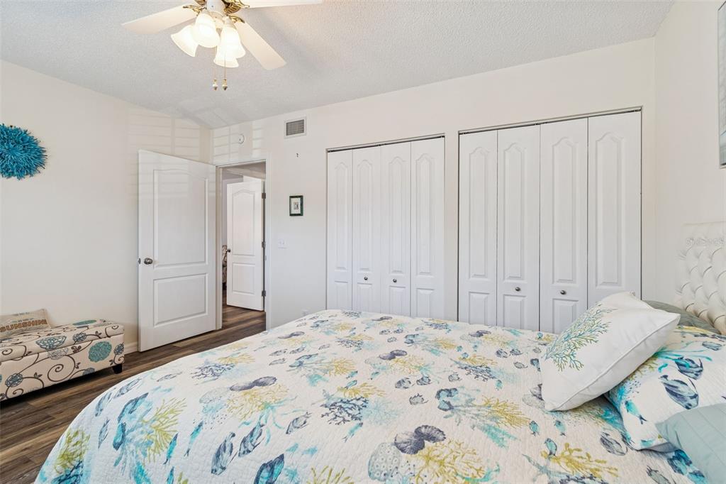 2291 Americus Boulevard West, Unit 3 Clearwater, FL 33763 - Photo 34 of 88 a bedroom with a bed and a chandelier