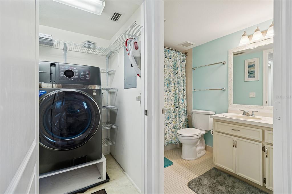 2291 Americus Boulevard West, Unit 3 Clearwater, FL 33763 - Photo 35 of 88 a view of a bathroom with washing machine and a sink