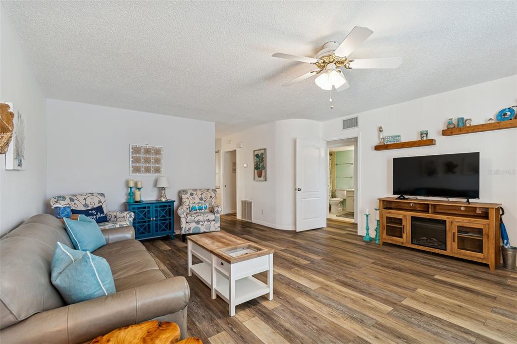 2291 Americus Boulevard West, Unit 3 Clearwater, FL 33763 - Photo 8 of 88 a living room with furniture and a flat screen tv