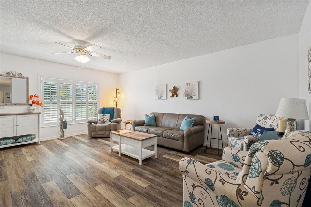2291 Americus Boulevard West, Unit 3 Clearwater, FL 33763 - Photo 9 of 88 a living room with furniture fireplace and a large window
