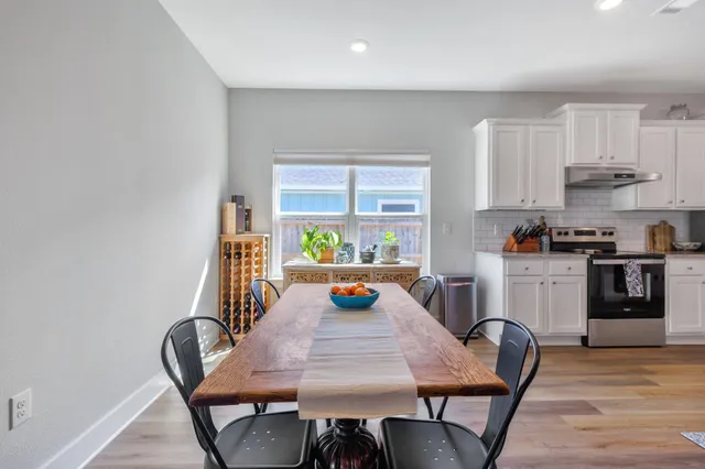 a spacious bedroom with a bed and a dresser