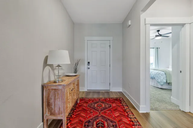 a living room with furniture a wooden floor and a table