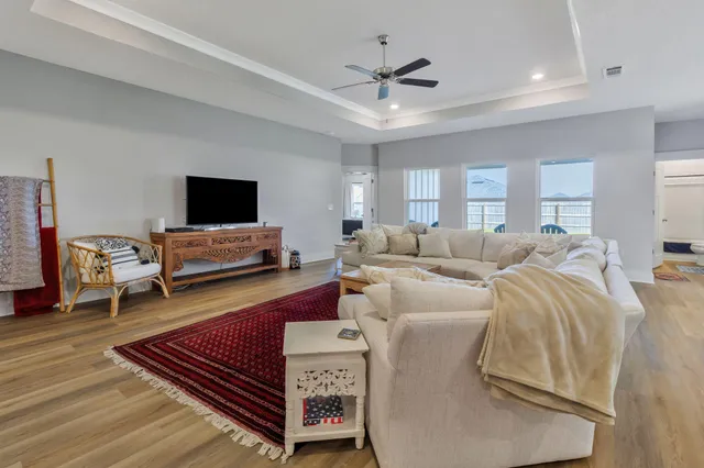 a living room with furniture and kitchen view