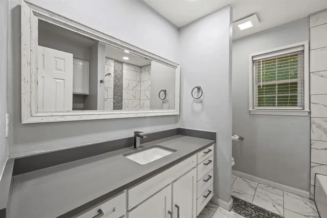 a bathroom with a sink a vanity and a mirror