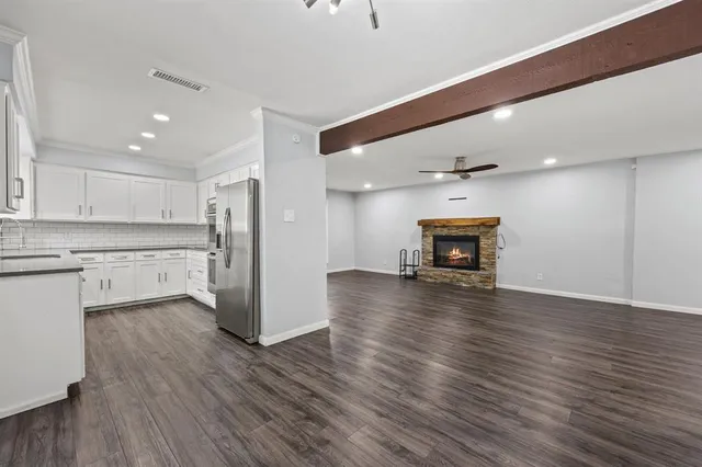 a view of a kitchen with a sink and a refrigerator