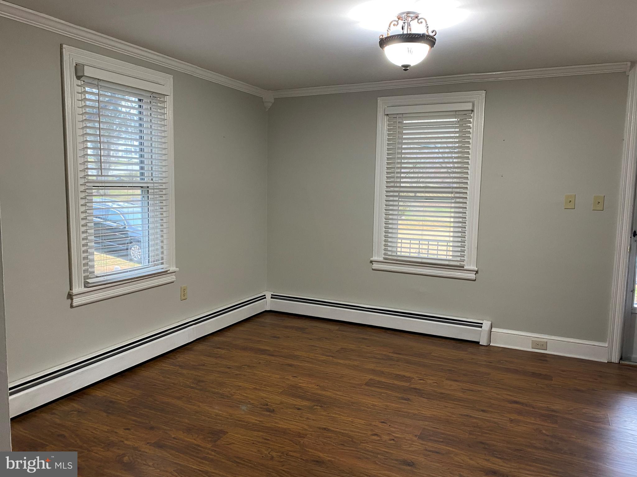 629 Convent Road Aston, PA 19014 - Photo 3 of 18 a view of an empty room with wooden floor and a window