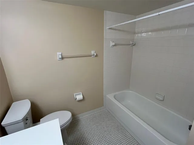 a bathroom with a toilet and a bath tub