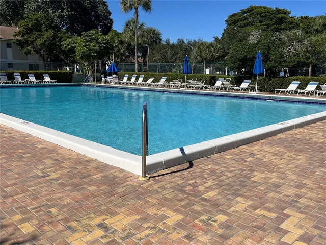 a view of a swimming pool and lounge chair