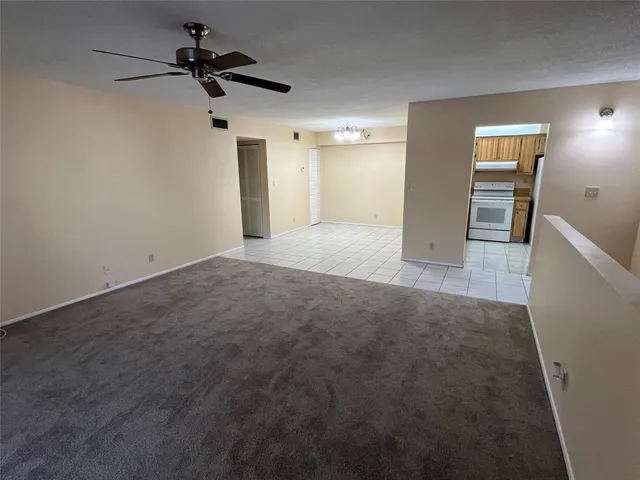 a view of a kitchen with a sink and refrigerator
