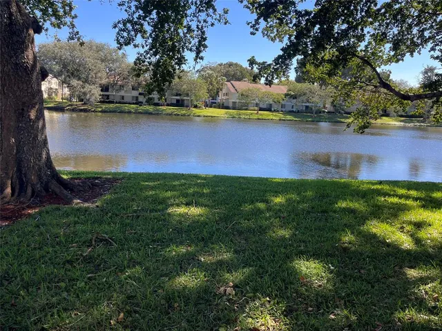 a view of a lake with houses in the back