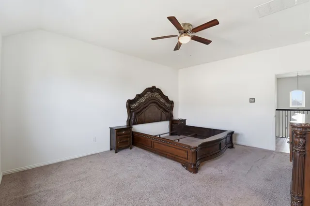 a living room with furniture and a ceiling fan