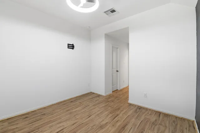 a view of a room with wooden floor