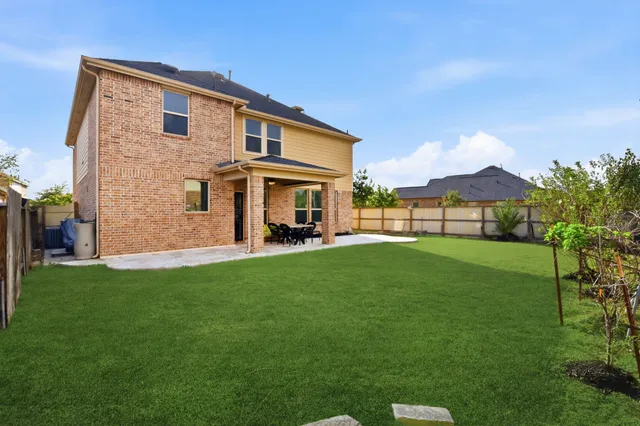 a view of a house with a yard and porch
