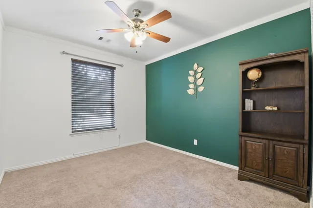 a view of a livingroom with a fan and a window
