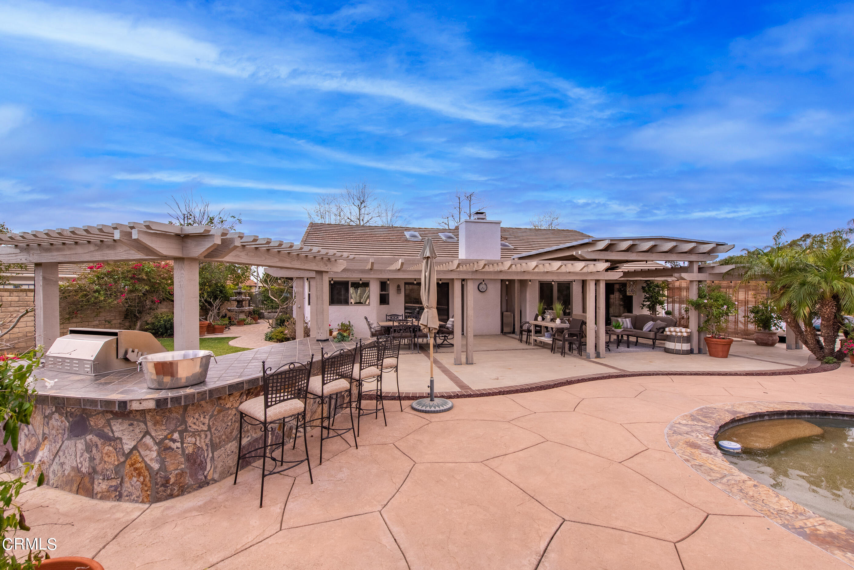 6893 Aviano Drive Camarillo, CA 93012 - Photo 43 of 67 a view of a patio with dining table and chairs with a barbeque grill and plants