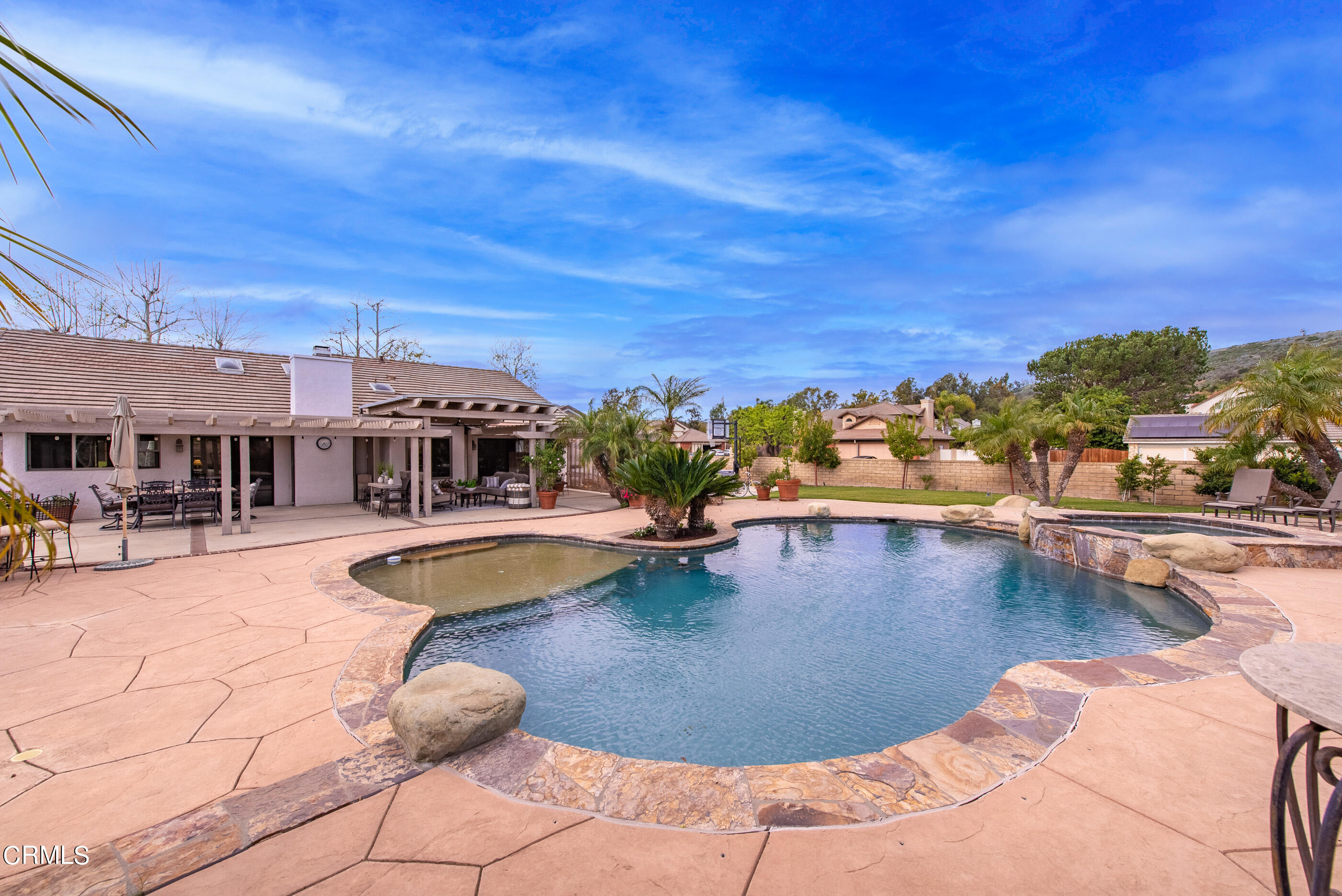 6893 Aviano Drive Camarillo, CA 93012 - Photo 45 of 67 a view of a swimming pool with a table and chairs