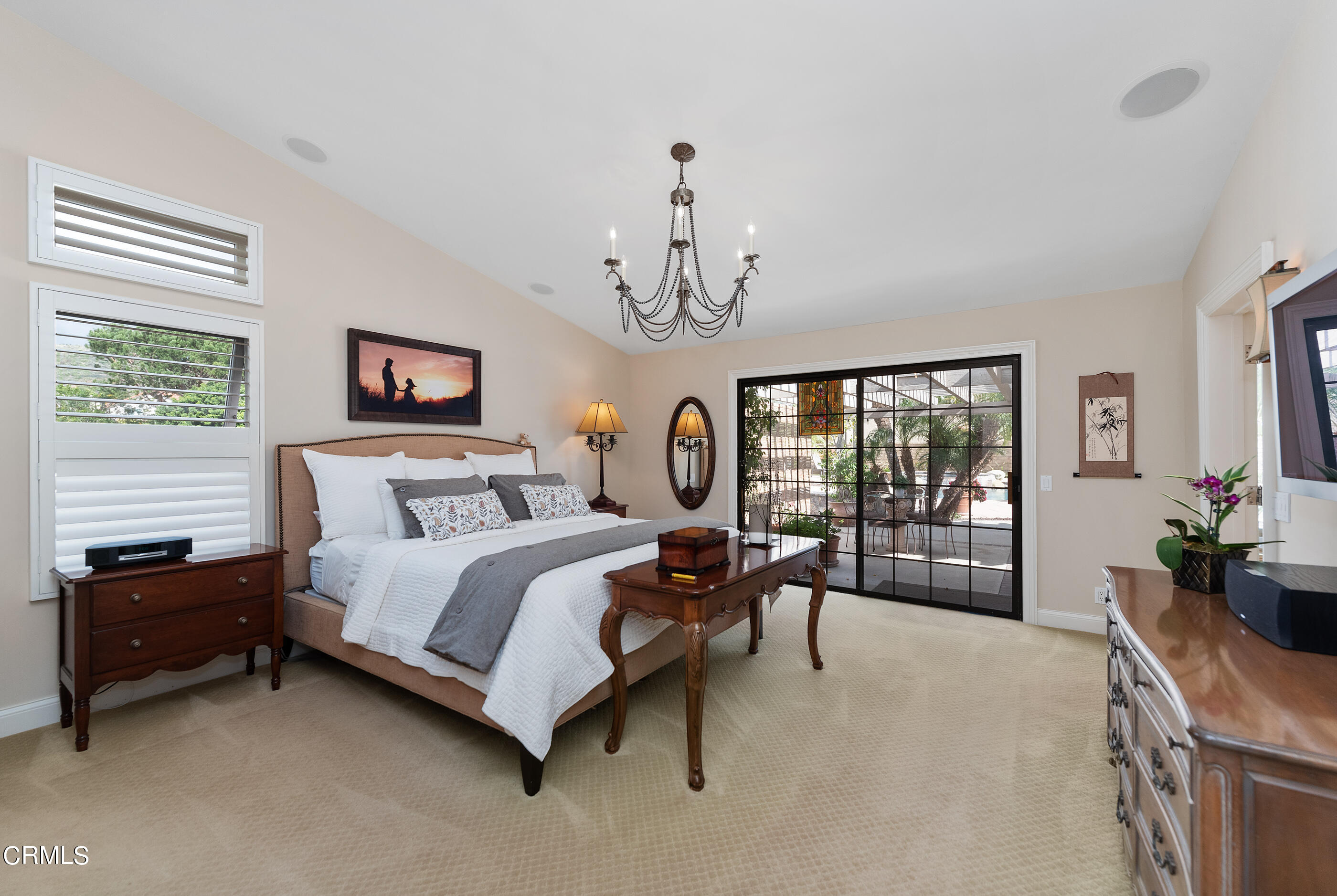 6893 Aviano Drive Camarillo, CA 93012 - Photo 6 of 67 a spacious bedroom with a bed a chandelier and a large window